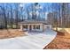 White house with gray roof, front porch, and long driveway at 1337 Fairfield Dr, Lilburn, GA 30047