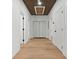 Clean hallway with light wood floors and white doors at 1337 Fairfield Dr, Lilburn, GA 30047