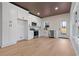 White shaker cabinets, stainless steel appliances, and wood floors at 1337 Fairfield Dr, Lilburn, GA 30047