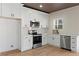 Modern kitchen with white cabinets and stainless steel appliances at 1337 Fairfield Dr, Lilburn, GA 30047