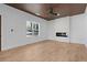 Bright living room with a fireplace, wood-look floors, and a wood accent ceiling at 1337 Fairfield Dr, Lilburn, GA 30047