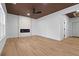 Open living area with wood-look floors, fireplace, and wood accent ceiling at 1337 Fairfield Dr, Lilburn, GA 30047