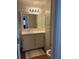Bathroom featuring a vanity, a mirror, a toilet, and a shower/tub with a striped curtain at 4876 Velva Nw Way, Lilburn, GA 30047
