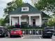 Charming bungalow with large front porch, dormer window, and colorful landscaping at 4876 Velva Nw Way, Lilburn, GA 30047