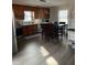 Eat-in kitchen with stainless steel appliances, wood cabinets, a tile backsplash, and modern lighting at 4876 Velva Nw Way, Lilburn, GA 30047