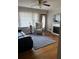 Bright living room featuring hardwood floors, a ceiling fan, a fireplace, and large windows at 4876 Velva Nw Way, Lilburn, GA 30047