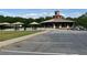 View of a parking lot, covered picnic area, and a public building with a clock tower at 4876 Velva Nw Way, Lilburn, GA 30047