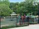 View of the neighborhood playground with climbing features, swings, and a covered gazebo at 4876 Velva Nw Way, Lilburn, GA 30047