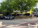 The Grove restaurant has outdoor seating, yellow umbrellas, and brick planters at 4876 Velva Nw Way, Lilburn, GA 30047
