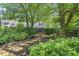 Landscaped backyard with stone patio and lush greenery at 1204 Bridle Path, Marietta, GA 30068