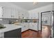 Modern kitchen with white cabinets and gray tile backsplash at 1204 Bridle Path, Marietta, GA 30068