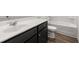 Bathroom with dark vanity, white toilet and bathtub at 2448 Lenox Se Rd, Conyers, GA 30094