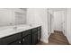 Modern bathroom with dark vanity and double sinks at 2448 Lenox Se Rd, Conyers, GA 30094
