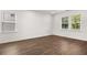 Bright bonus room featuring wood-look floors and multiple windows at 2448 Lenox Se Rd, Conyers, GA 30094