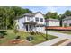 Two-story house with white siding, gray accents, and a two-car garage at 2448 Lenox Se Rd, Conyers, GA 30094
