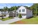 Two-story house with white siding, gray accents, and a two-car garage at 2448 Lenox Se Rd, Conyers, GA 30094