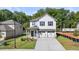 Two-story house with white siding, gray accents, and a two-car garage at 2448 Lenox Se Rd, Conyers, GA 30094