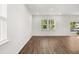 Open living room with wood-look floors and access to a patio at 2448 Lenox Se Rd, Conyers, GA 30094