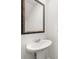 Elegant powder room with pedestal sink and ornate mirror at 2448 Lenox Se Rd, Conyers, GA 30094