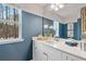 Stylish bathroom with quartz counters, white cabinetry, and a modern mirror at 215 Sanctuary Dr, Mcdonough, GA 30253