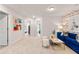 Open loft with colorful artwork, a comfortable blue sofa, and contemporary décor at 219 Sanctuary Dr, Mcdonough, GA 30253