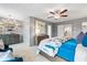 Main bedroom featuring soft wall paneling, a ceiling fan, and a comfortable sitting area at 219 Sanctuary Dr, Mcdonough, GA 30253