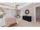 Bright primary bedroom with a four poster bed, chic wallpaper and abundant natural light at 223 Sanctuary Dr, Mcdonough, GA 30253