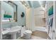 Clean bathroom with a bathtub, shower, and pedestal sink at 1452 Merriman Ne Ln, Atlanta, GA 30324