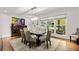 Bright dining room features hardwood floors, a glass table, and seating for six at 1452 Merriman Ne Ln, Atlanta, GA 30324