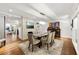 Open concept dining room with hardwood floors, stone fireplace, and seating for six at 1452 Merriman Ne Ln, Atlanta, GA 30324