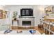 Open living room showcasing a fireplace, built-in bar, and hardwood floors at 1452 Merriman Ne Ln, Atlanta, GA 30324