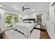 King-size bedroom with hardwood floors, ample natural light, and ceiling fan at 1452 Merriman Ne Ln, Atlanta, GA 30324
