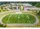 Aerial view of school grounds featuring an athletic field, track, and well-kept grounds at 1195 Fielding Way, Marietta, GA 30068