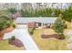 Beautiful home with a spacious driveway, mature landscaping, and lush greenery at 1195 Fielding Way, Marietta, GA 30068