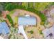 Aerial view of a home with a well-manicured lawn and mature trees surrounding the property in a suburban setting at 1195 Fielding Way, Marietta, GA 30068