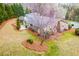 Aerial view of the lush backyard and the back of the home, with mature flowering trees and landscaping at 1195 Fielding Way, Marietta, GA 30068