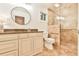 Well lit bathroom featuring granite counters, stylish cabinetry, round mirror, and accessible walk-in tiled shower at 1195 Fielding Way, Marietta, GA 30068