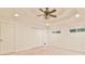 Spacious bedroom with a tray ceiling, ceiling fan, and bright windows at 1195 Fielding Way, Marietta, GA 30068