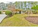 Charming ranch-style home featuring a stone accent wall, manicured lawn, and mature landscaping at 1195 Fielding Way, Marietta, GA 30068