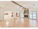 Open living room with hardwood floors, stone fireplace, and access to kitchen at 1195 Fielding Way, Marietta, GA 30068