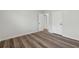 Empty bedroom with hardwood floors and white doors at 1573 Deerwood Ln, Acworth, GA 30102