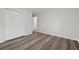 Spacious bedroom with wood-look floors and double doors at 1573 Deerwood Ln, Acworth, GA 30102