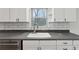 Renovated kitchen with white cabinets and gray countertops at 1573 Deerwood Ln, Acworth, GA 30102