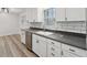 Modern kitchen with white cabinets and gray countertops at 1573 Deerwood Ln, Acworth, GA 30102