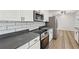 Updated kitchen with stainless steel appliances and gray countertops at 1573 Deerwood Ln, Acworth, GA 30102