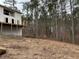 Cleared lot behind new home construction, showing wooded area at 515 Penny Ln, Loganville, GA 30052