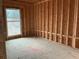 New home bedroom framing with window view at 515 Penny Ln, Loganville, GA 30052