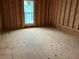 New bedroom framing with window and flooring at 515 Penny Ln, Loganville, GA 30052
