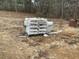 Cement bags and bricks on a lot prepared for construction at 515 Penny Ln, Loganville, GA 30052