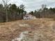 View of two-story home with red roof in construction phase on a large lot at 515 Penny Ln, Loganville, GA 30052